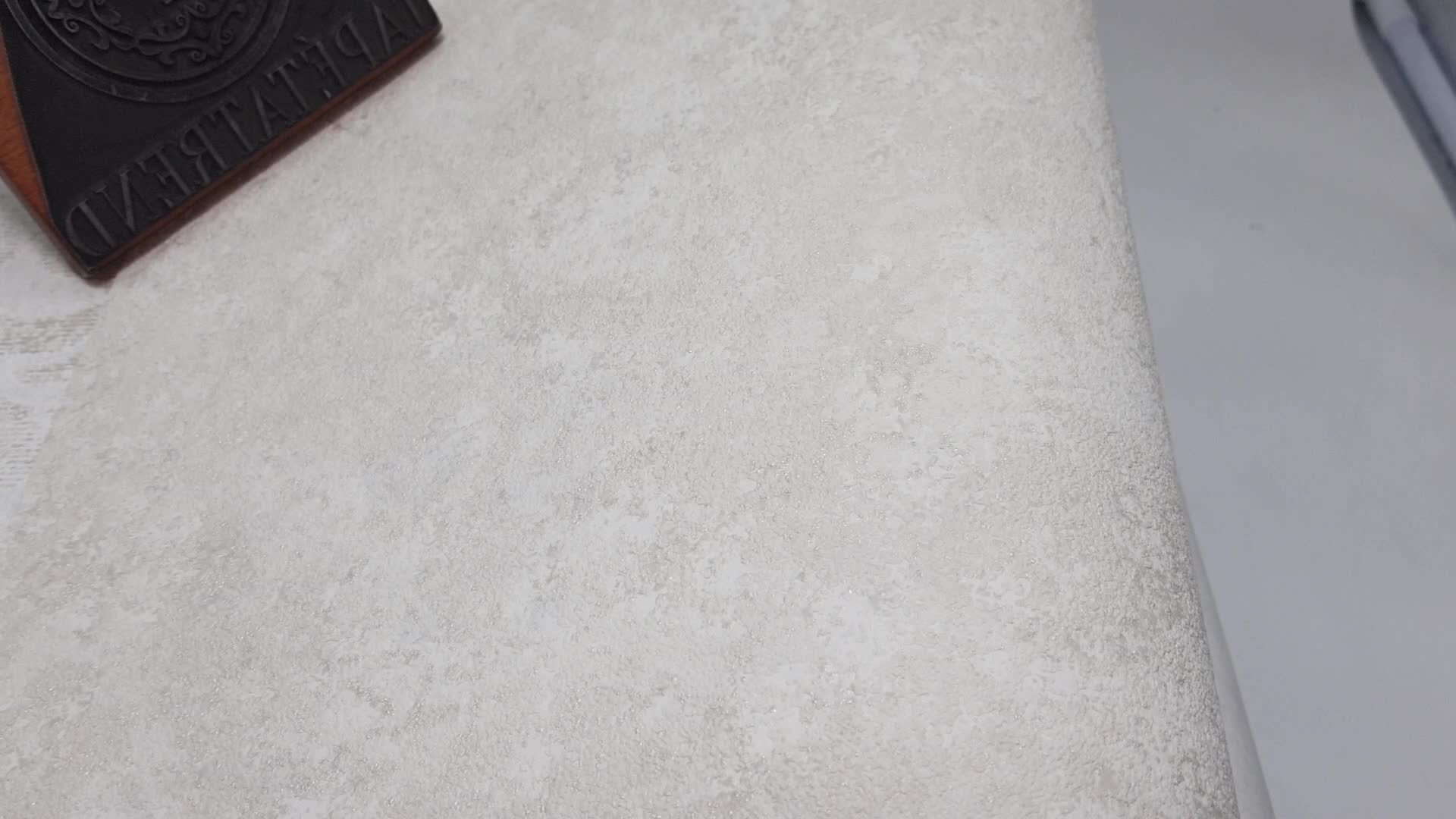 Egyszínű struktúrált világos beige metálos koptatott design tapéta