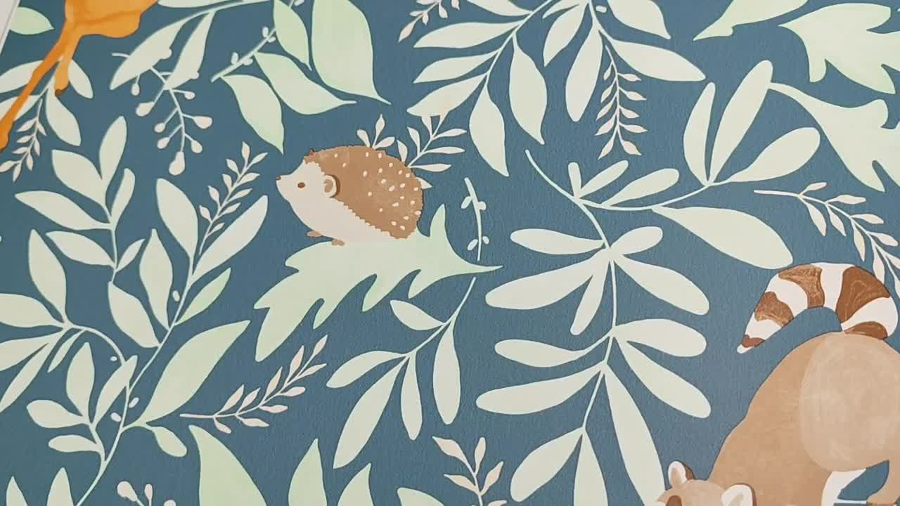 Gyerek design tapéta kékes alapon zöld levél és állatos mintával