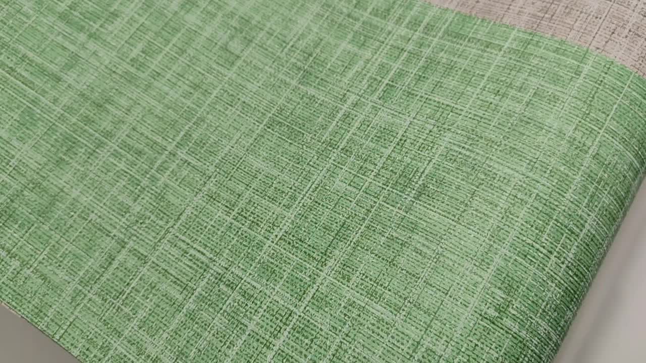 Dekor tapéta zöld színű szőtt hatású mintával